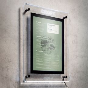Illuminated outdoor menu display case wall mounted at restaurant entrance, backlit LED panel, portrait orientation